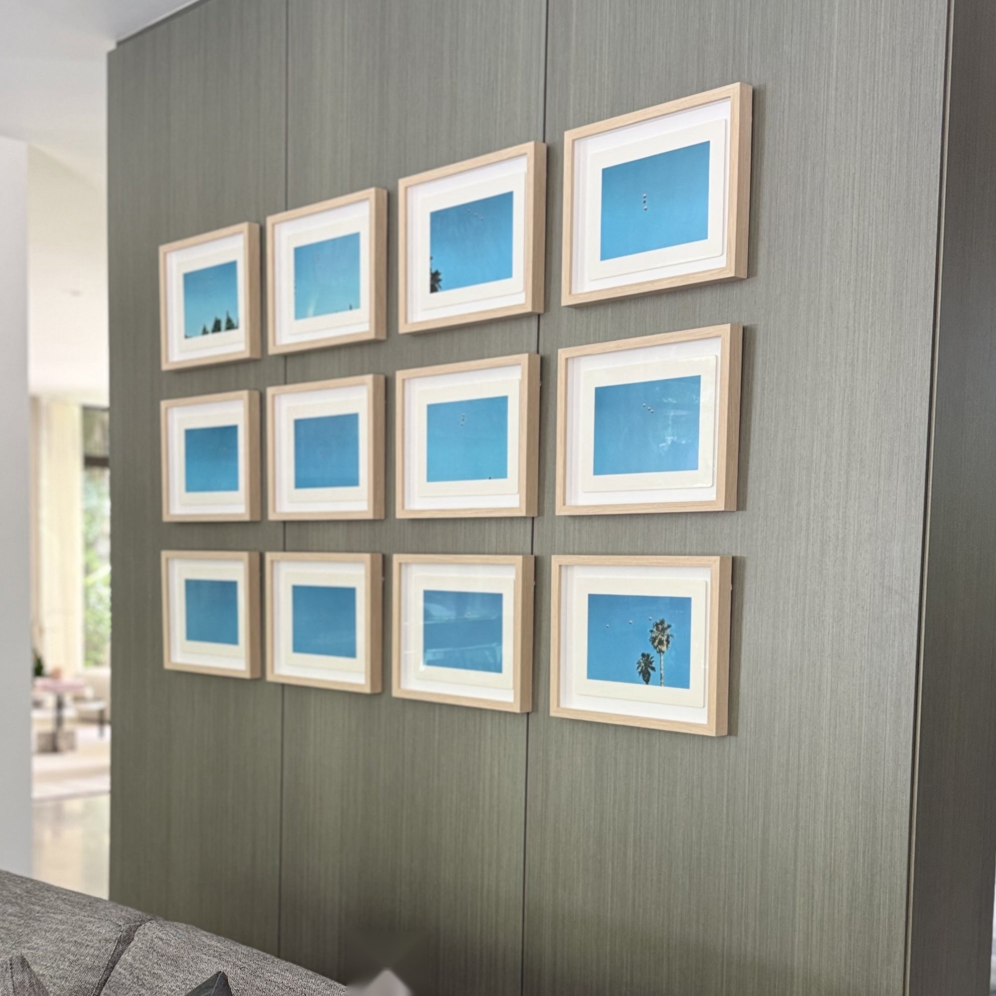 Framed photography wall on grasscloth panelling
